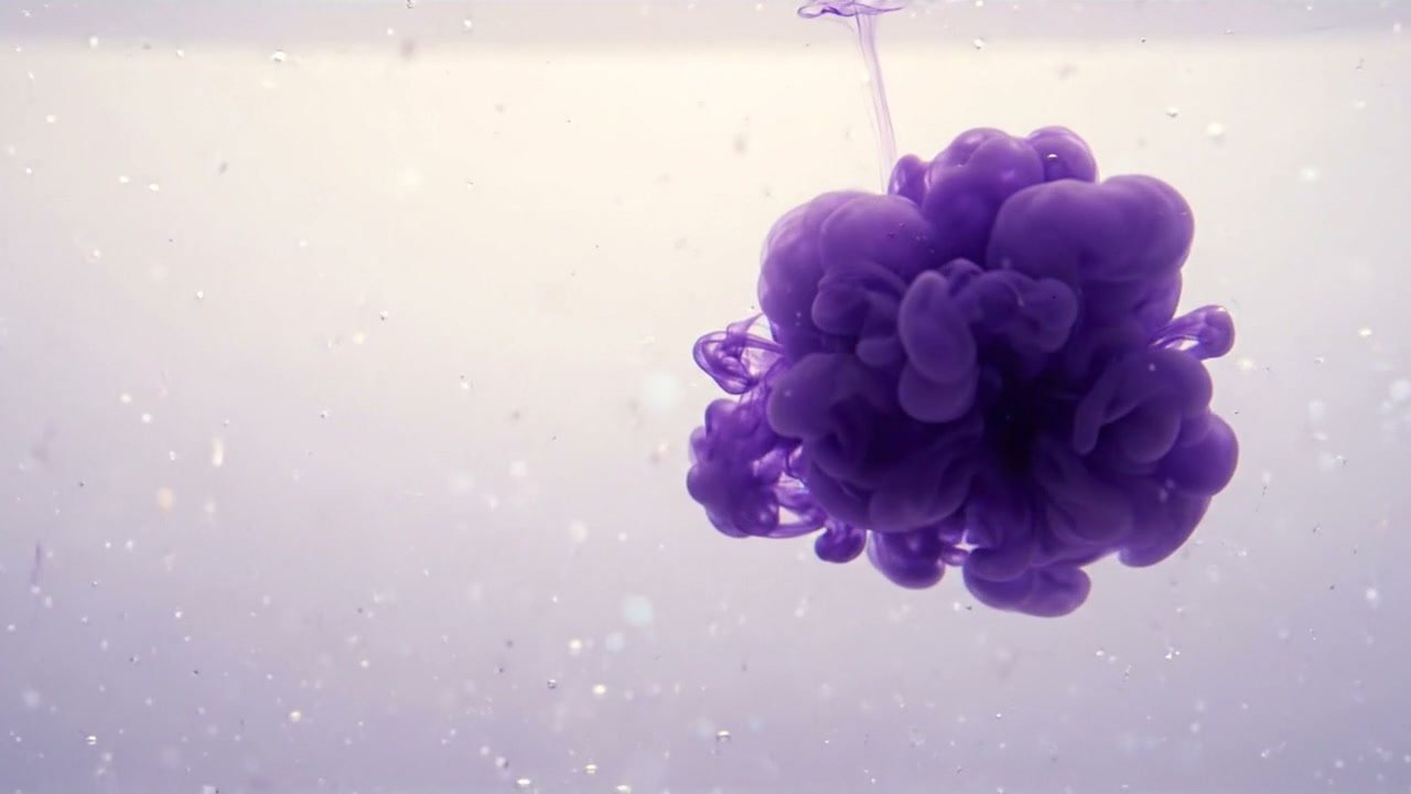 Violet ink blooming outward in pale water